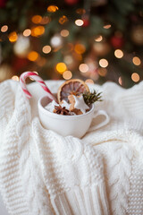 wicker basket, knitted sweater, dried citruses, cinnamon sticks, Christmas cookies, Christmas lights. Cozy.