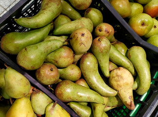 Boxes with fresh pears in the supermarket