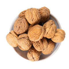 Shelled walnuts on white ceramic bowl