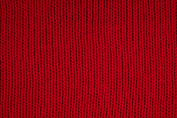 background of red knitted fabric close up
