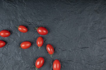 Close up photo of Small cherry tomatoes on black background