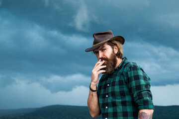 Obraz premium bearded man. texas brutal cowboy. brutal hipster with moustache in hat. fashion model wear casual west clothes. male beauty standard. looking so trendy. Confident and handsome man. Country music