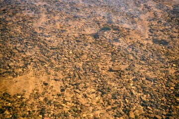 Abstract Underwater Texture Natural Background. Detail of stones and pebbles on the bottom of water