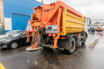 Fototapeta premium The machine that sprinkles salt on the road in winte
