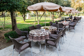 Outdoor tables and Chairs of coffee shop in autumn season in Golestan Palace in Tehran, Iran