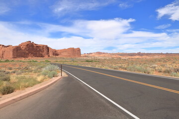 Fototapeta na wymiar Arches National Park scenic byway winds through sandstone landscapes