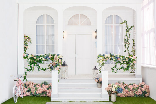 Classic white terrace. Spring pretty background. Spring and Easter mood. Shabby chic style. Country veranda in spring decoration. Backdrop for photography