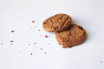 Chocolate chip cookies with crumbs isolated on white background