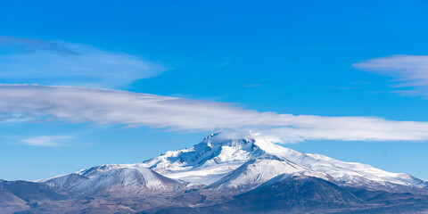 Fototapeta na wymiar Erciyes mount in Kayseri. Snowy scarlet mountain. Erciyes is a large stratovolcano, reaching a height of 3,864 m it the highest mountain and most voluminous volcano of Central Anatolia
