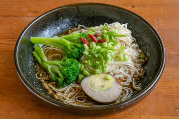 The close up of Taiwan homemade thin noodles with sesame oil, Taiwanese traditional famous food on wooden table.