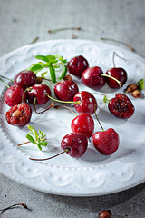 Cherry on white plate on white background