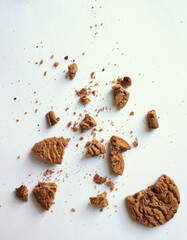 Chocolate chip cookies with crumbs isolated on white background