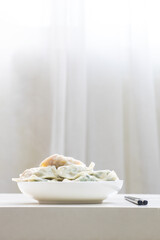 A plate of steaming three fresh dumplings