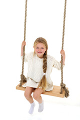 Cute long haired girl sitting on rope swing