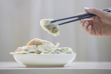 A plate of steaming three fresh dumplings