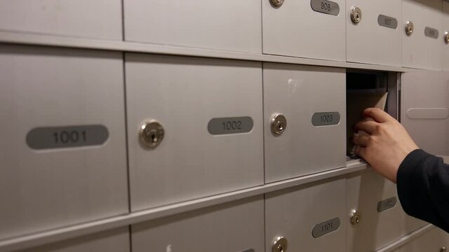 Woman taking a mail from her mailbox