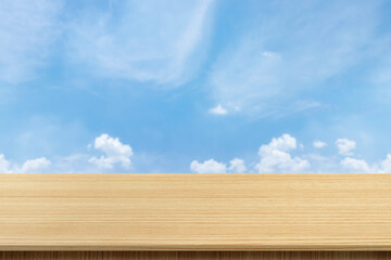 Empty wooden board table with blurred background. Perspective brown wood over blur the sky and clouds - can be used to display or edit your products, simulate to showcase them.