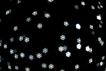 The bokeh background lights, festive snow flakes