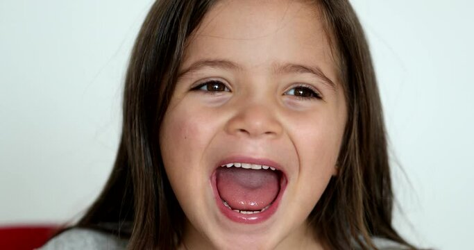 Happy little girl child face close-up smiling