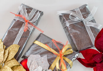 Wrapped Christmas Gifts and cake with Christmas decorations in Silver, Gold and Red