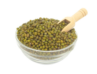 Mung beans in glass bowl with wooden scoop isolated on white background