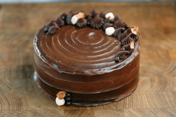 Chocolate cake made of loose dough on a wooden table. Sliced cake with caramel filling.
