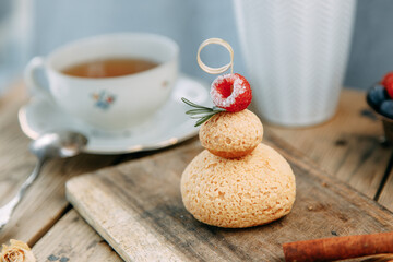 Custard cake with chocolate and berry filling. Round cake with mousse cream on a wooden table.