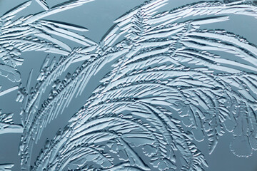 Blue patterns from frost on glass as a background.
