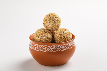 Indian sweet for traditional festival makar sankranti :Rajgira laddu made from Amaranth seed in Bowl on white background