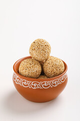 Indian sweet for traditional festival makar sankranti :Rajgira laddu made from Amaranth seed in Bowl on white background