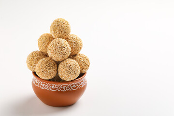 Indian sweet for traditional festival makar sankranti :Rajgira laddu made from Amaranth seed in Bowl on white background