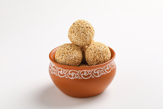Indian sweet for traditional festival makar sankranti :Rajgira laddu made from Amaranth seed in Bowl on white background