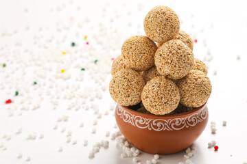 Indian sweet for traditional festival makar sankranti :Rajgira laddu made from Amaranth seed in Bowl on white background