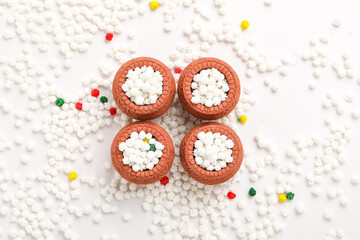 Indian festival makar sankranti concept : Tilgul in small bowl. Tilgul is a colourful sesame candy coated with sesame seeds; in Maharashtra people exchange tilgul on Sankranti