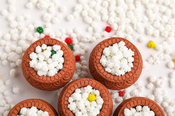 Indian festival makar sankranti concept : Tilgul in small bowl. Tilgul is a colourful sesame candy coated with sesame seeds; in Maharashtra people exchange tilgul on Sankranti