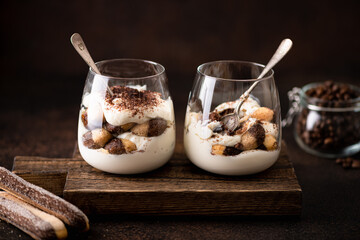 tiramisu dessert in a glass on a dark background