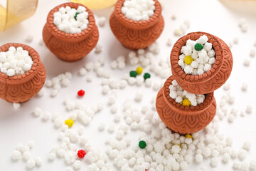 Indian festival makar sankranti concept : Tilgul in small bowl. Tilgul is a colourful sesame candy coated with sesame seeds; in Maharashtra people exchange tilgul on Sankranti