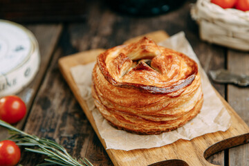 Pie with chicken and mushrooms from puff pastry. Pies cut in half close-up.