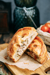 Cake of puff pastry with salmon. Pie cut close-up with fish.