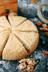 Sour cream cake cut in close-up. Sweet dessert with cream on the table.