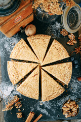 Sour cream cake cut in close-up. Sweet dessert with cream on the table.
