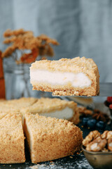 Sour cream cake cut in close-up. Sweet dessert with cream on the table.