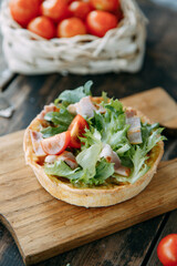 Hot appetizer with mushrooms, chicken and herbs. Tartlet made of yeast-free dough close-up.