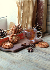 old books, cinnamon, tea Cup and cookies. Tea party. cozy home, comfort concept. winter season. hugge atmosphere