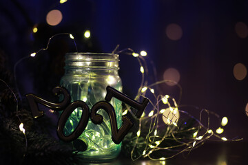 Holiday led light garland in jar with number 2021. Christmas, new year holiday celebration concept. Copy space.