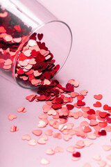 a glass of champagne with glitter in the form of hearts. postcard for valentine's day. copyspace. 