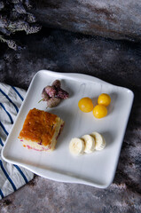 fruit cake, plum, banana, berry on the plate