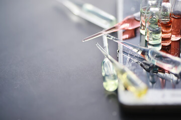 Test tubes with drugs and tests to test the victims and treat the infected. Ampoules with medicines. Set of test tubes with medicine.