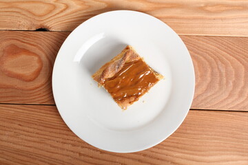 Shortcrust pastry cake covered with fudge caramel cream. Mazurek, Poland.