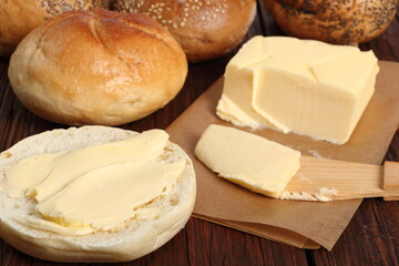 Fototapeta na wymiar Spreading butter on bread roll